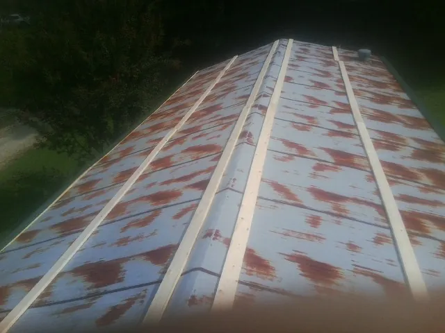 Rusted metal roof panels with new wood purlins before replacement — Storm Damage Roof Repair in Nescopeck by Roofing Brothers